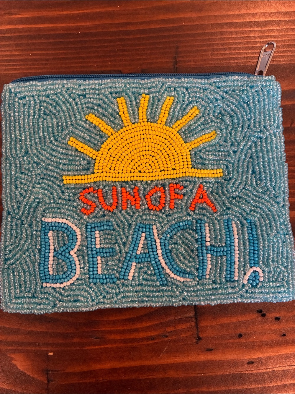 SUNO Teal Beaded 'Sun of a Beach' Pouch with Yellow Sun and Orange Lettering